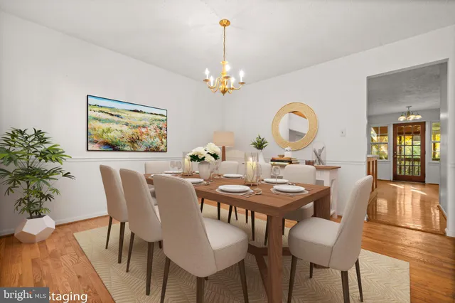 a view of a dining room with furniture and chandelier