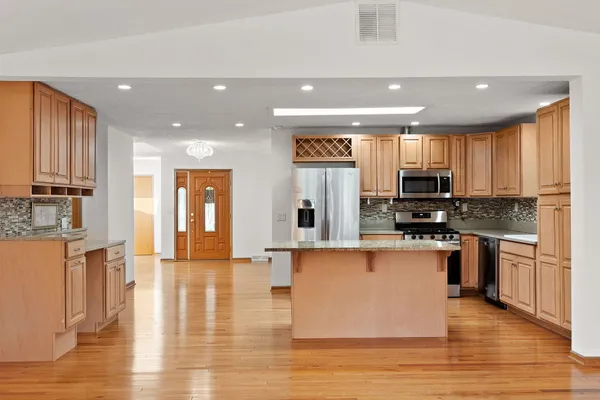 a large kitchen with stainless steel appliances lots of counter space and a sink