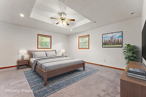 a bedroom with a large bed and a chandelier