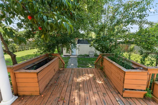 a view of deck with seating and trees
