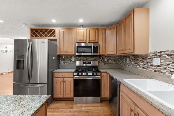 a kitchen with a sink stove and refrigerator