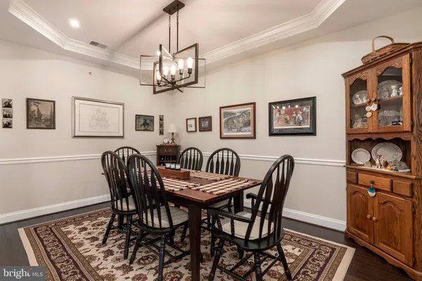 a kitchen with stainless steel appliances granite countertop a refrigerator stove and white cabinets