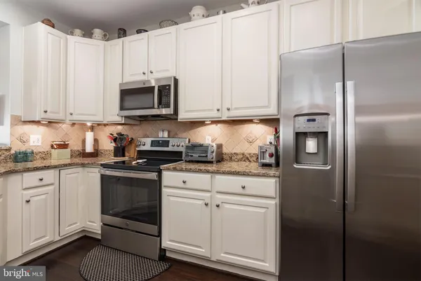 a living room with furniture ceiling fan and a rug