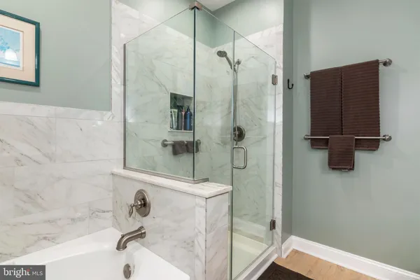 a bed room with a bed television and a large window