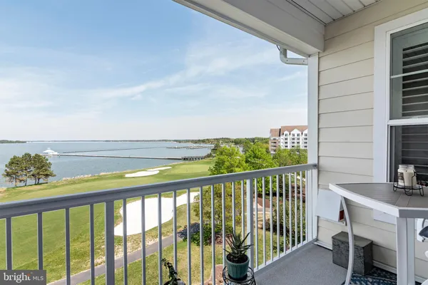 a view of ocean with boats and trees in the background