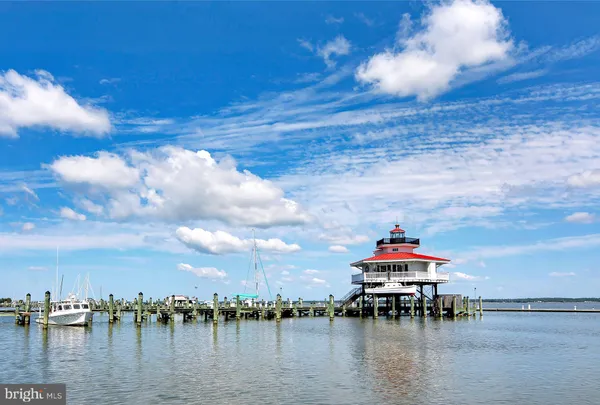 a bedroom with two beds and a dresser
