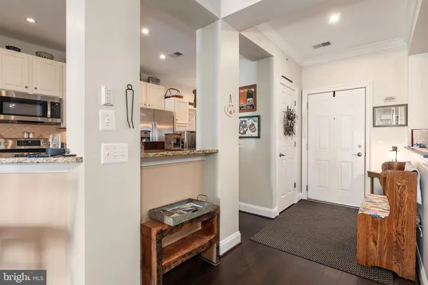 a view of a dining room and hall with furniture