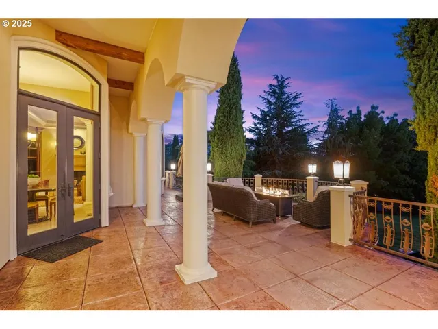 a living room with furniture a fireplace and a large mirror