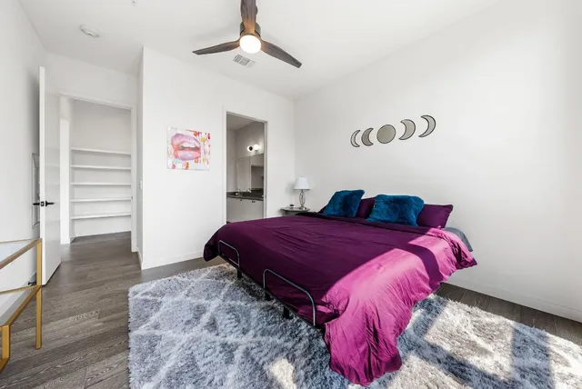 a bed sitting in a bedroom next to a window