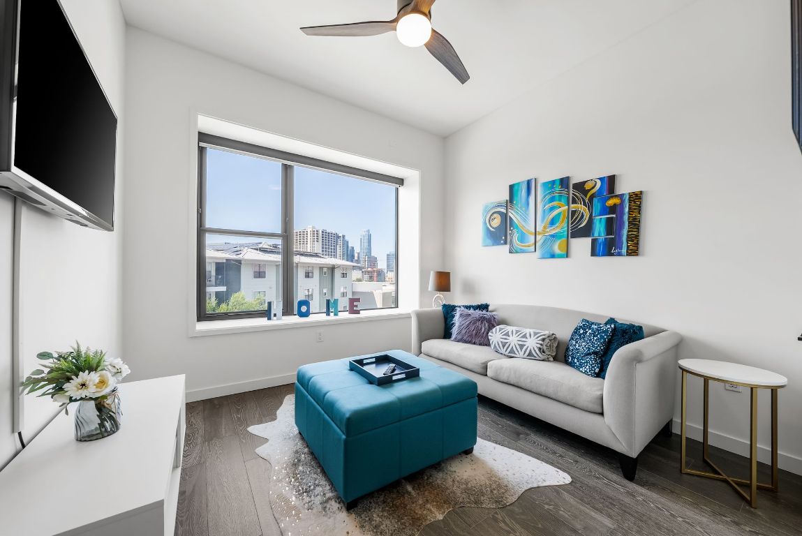 800 Embassy Drive, Unit 337 Austin, TX 78702 - Photo 12 of 29 a living room with furniture and a flat screen tv