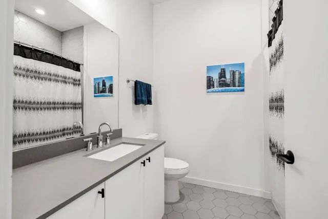 a bathroom with a toilet sink and shower