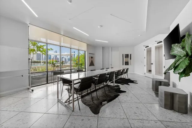 a living room with patio furniture and a flat screen tv