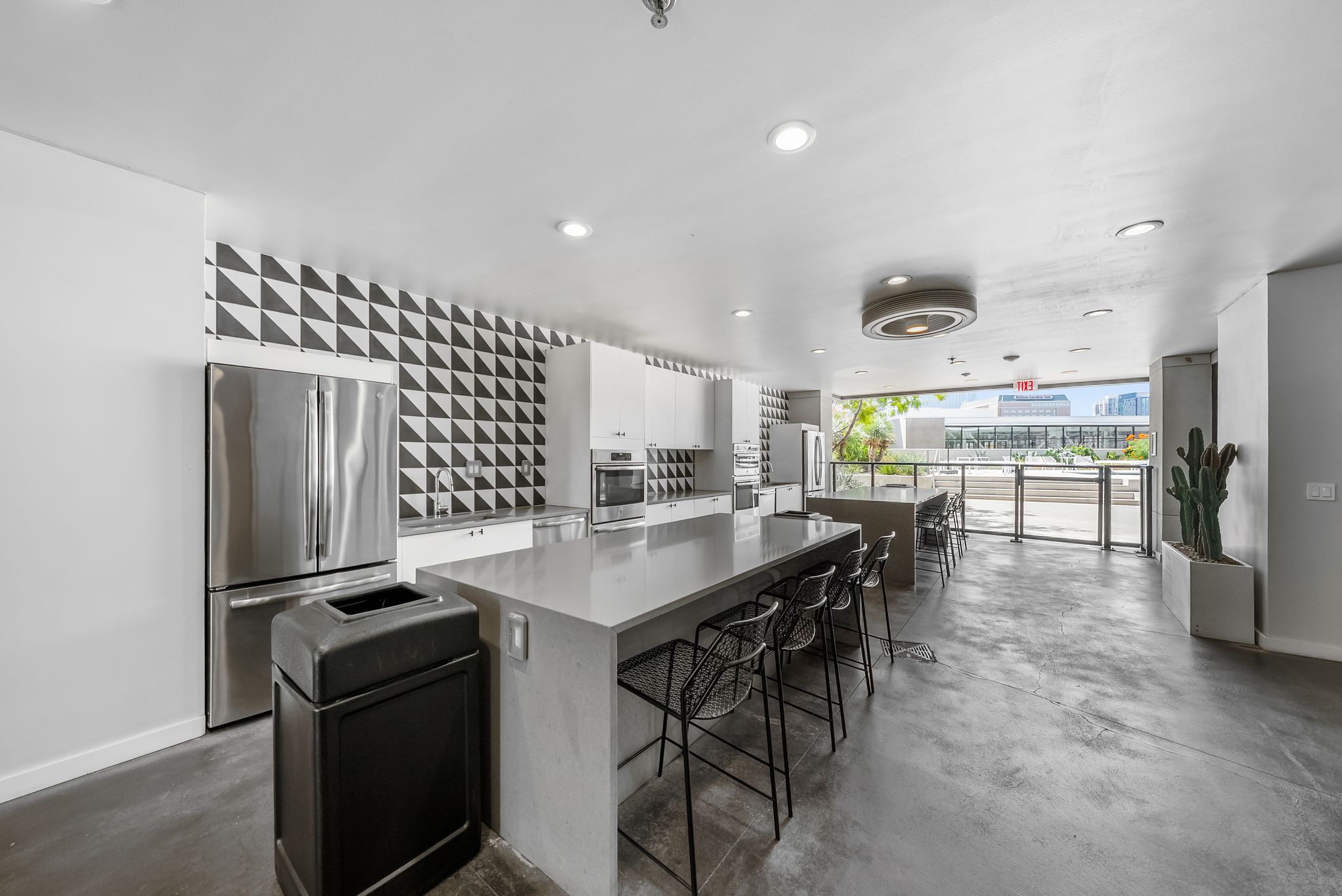 800 Embassy Drive, Unit 337 Austin, TX 78702 - Photo 24 of 29 a kitchen with stainless steel appliances kitchen island a table and chairs in it