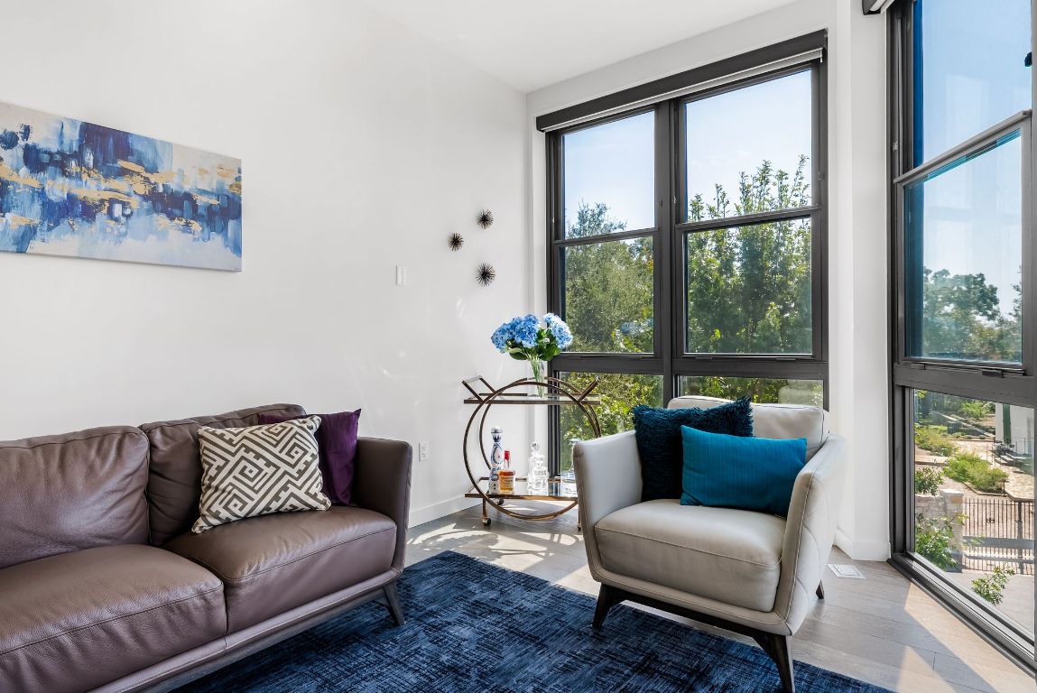 800 Embassy Drive, Unit 337 Austin, TX 78702 - Photo 3 of 29 a living room with furniture and a large window
