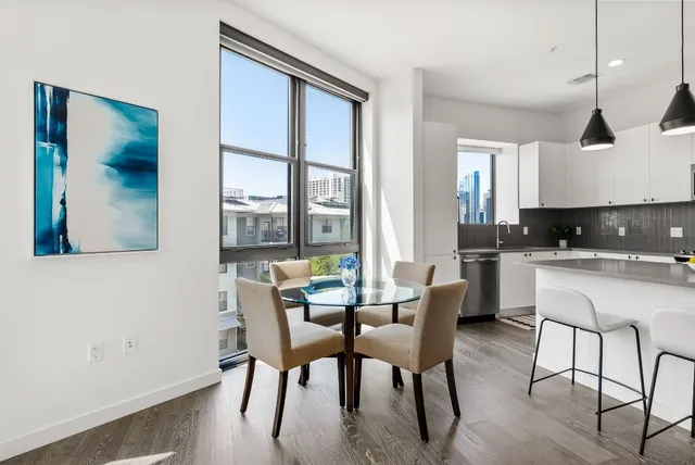 a kitchen with stainless steel appliances a stove a sink and a refrigerator