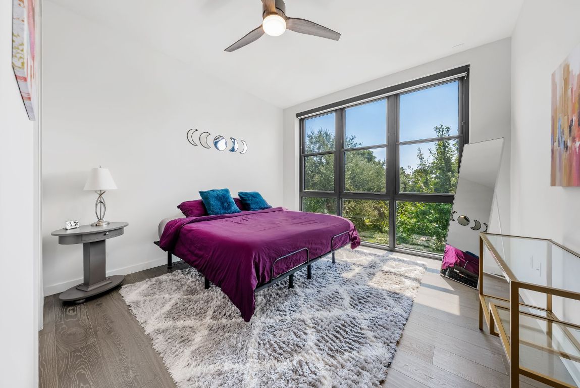 800 Embassy Drive, Unit 337 Austin, TX 78702 - Photo 9 of 29 a bed sitting in a bedroom next to a window