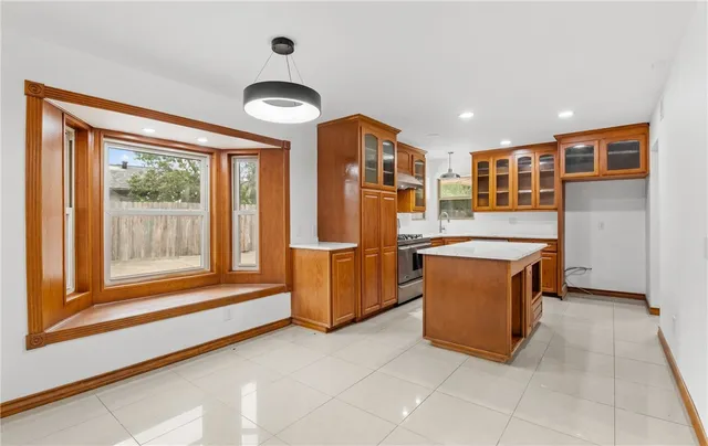a view of kitchen with stainless steel appliances granite countertop a stove top oven