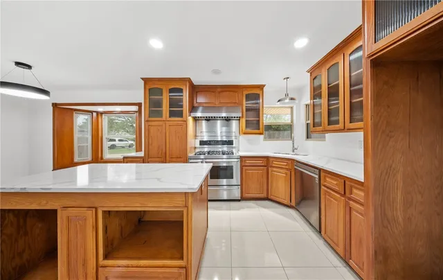 a kitchen with a sink stove and cabinets