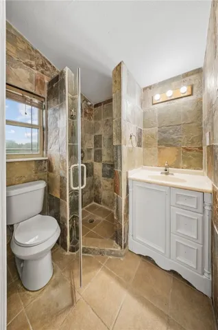 a bathroom with a toilet sink and a shower