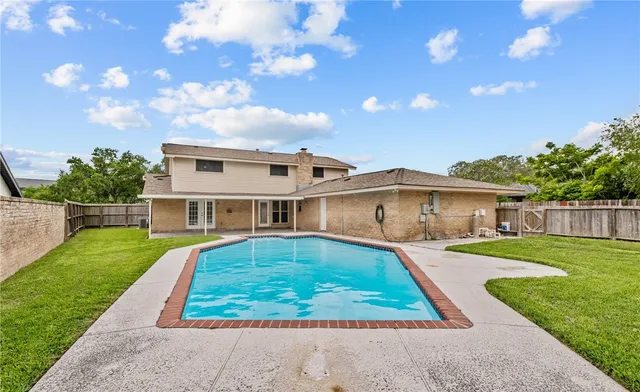 a view of house with swimming pool