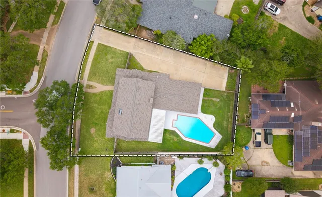 an aerial view of houses with an outdoor space