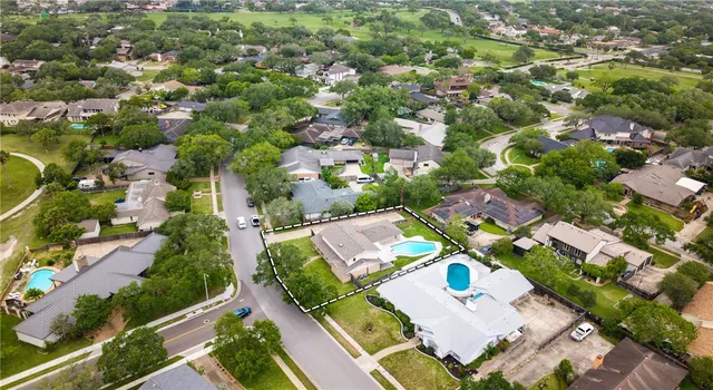 an aerial view of residential houses with outdoor space