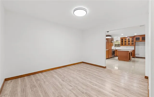 a view of a room with furniture and wooden floor