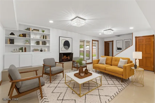 a living room with furniture a rug and a window