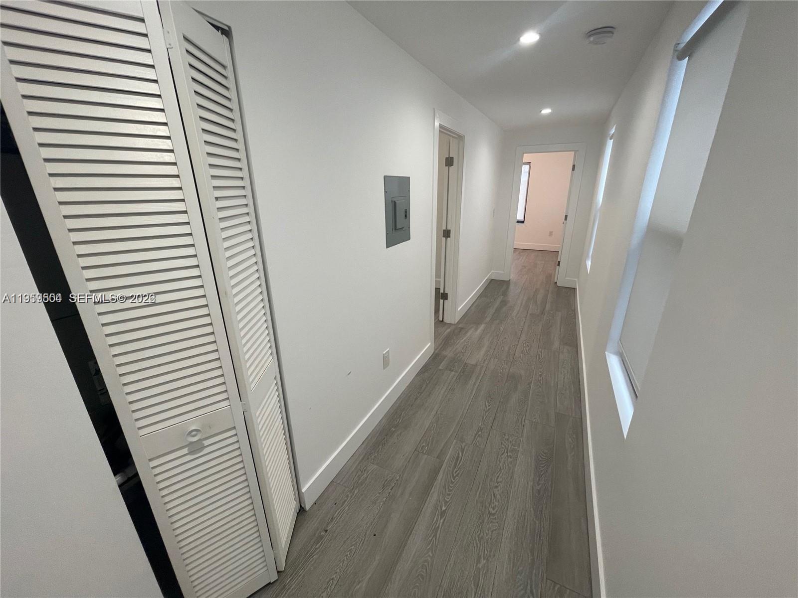 1637 Southwest 10th Street, Unit 2 Miami, FL 33135 - Photo 6 of 9 a view of a hallway with wooden floor and staircase