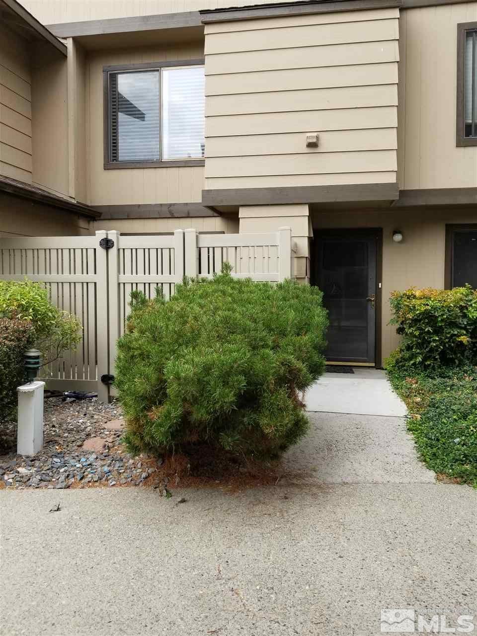 4597 Reggie Road Reno, NV 89502 - Photo 1 of 9 a front view of a house with garden