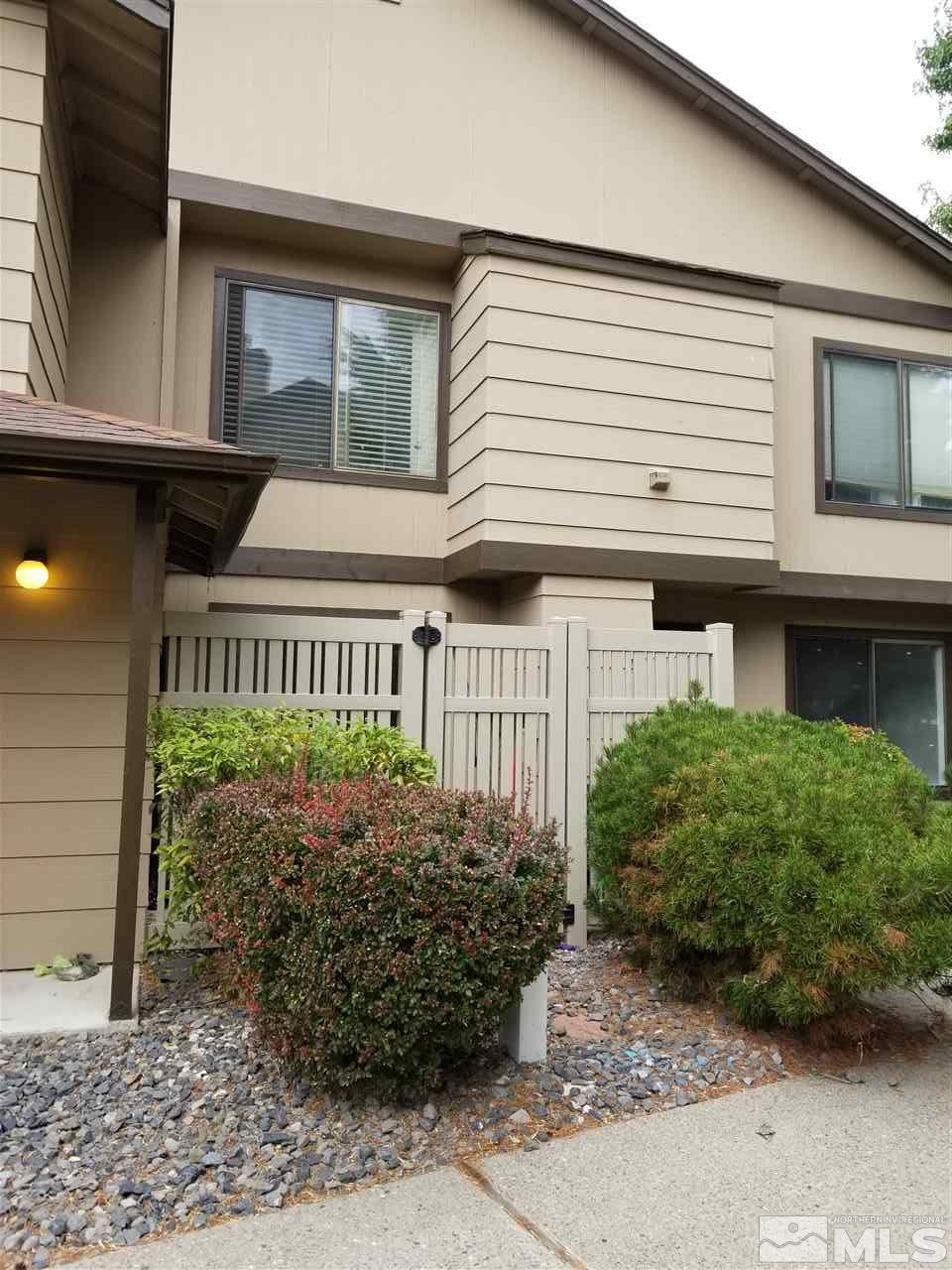 4597 Reggie Road Reno, NV 89502 - Photo 2 of 9 a front view of a house with garden