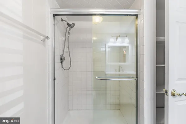 a bathroom with a glass shower door