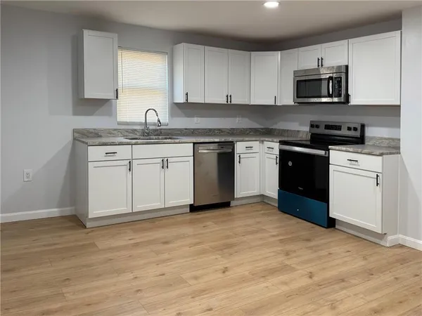 a view of a room with wooden floor and window
