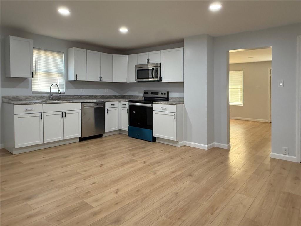 1252 Jefferson Street Vandergrift, PA 15690 - Photo 13 of 22 a kitchen with granite countertop a stove top oven sink and cabinets