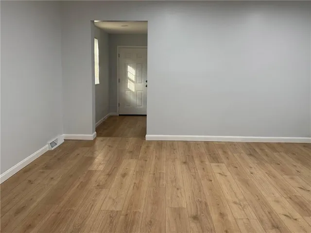 a bathroom with a granite countertop toilet sink and mirror