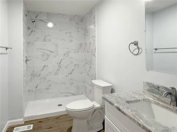 a view of a room with wooden floor