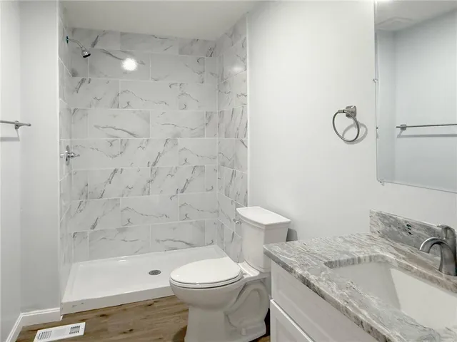 a view of a room with wooden floor