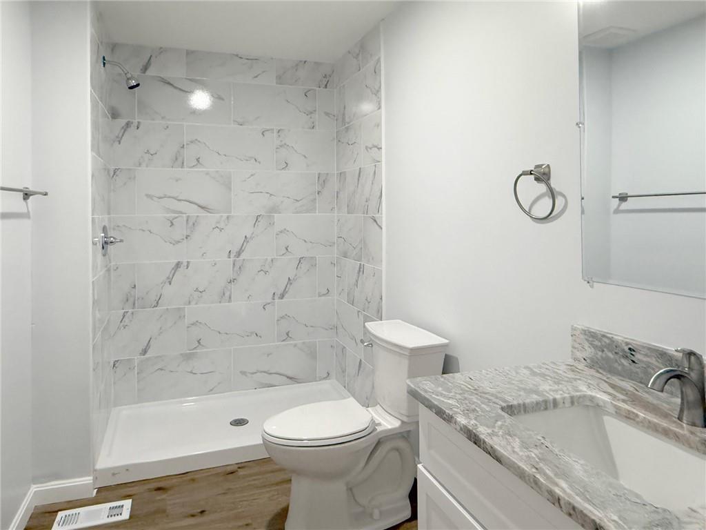 1252 Jefferson Street Vandergrift, PA 15690 - Photo 15 of 22 a bathroom with a granite countertop toilet a sink and a bathtub