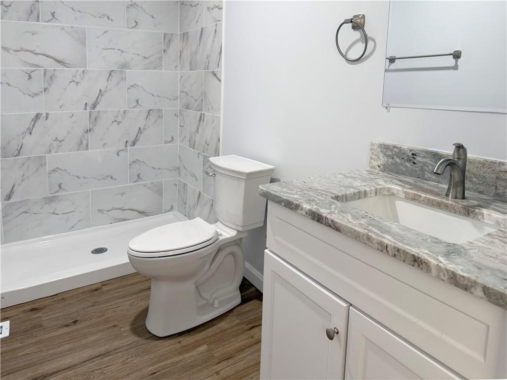 1252 Jefferson Street Vandergrift, PA 15690 - Photo 16 of 22 a bathroom with a granite countertop toilet sink and mirror