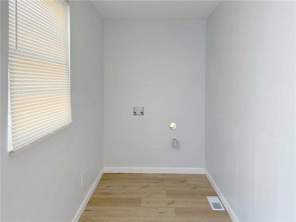 1252 Jefferson Street Vandergrift, PA 15690 - Photo 19 of 22 an empty room with wooden floor and windows