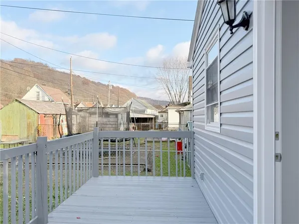 a view of balcony with wooden floor