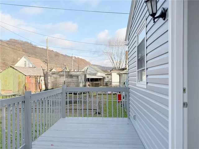 a view of balcony with wooden floor