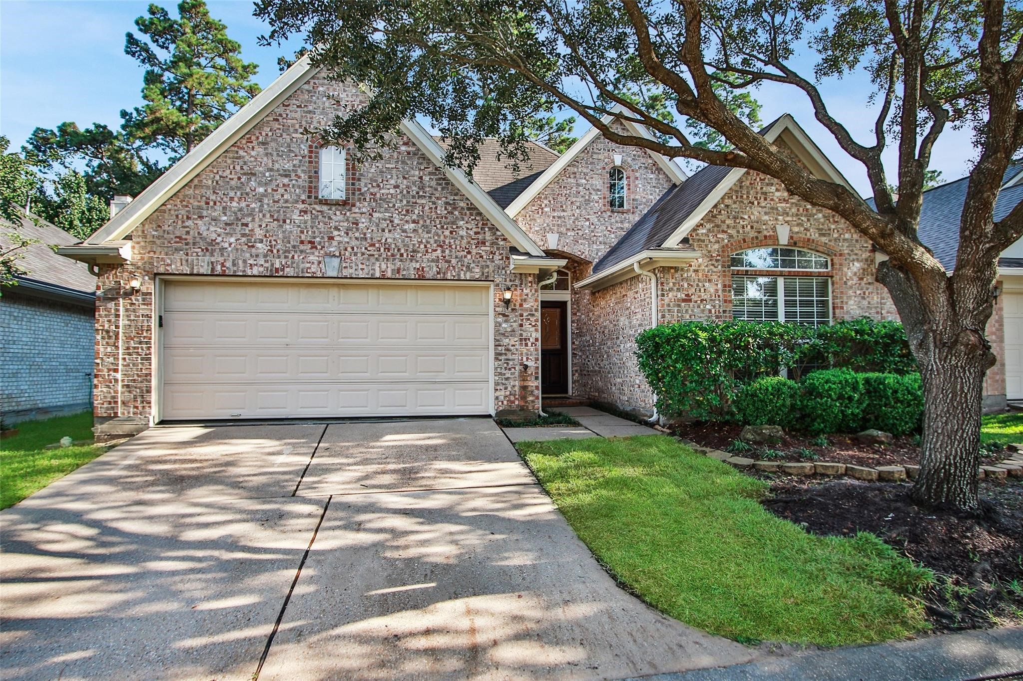 3415 Candlepine Drive Spring, TX 77388 - Photo 21 of 23 a front view of a house with a garden and trees