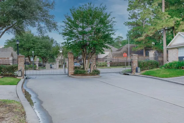 front view of a house with a yard and an trees