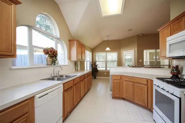 a kitchen with stainless steel appliances a sink a stove and cabinets