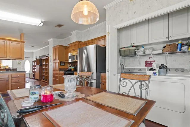 a kitchen with stainless steel appliances granite countertop a refrigerator sink and cabinets