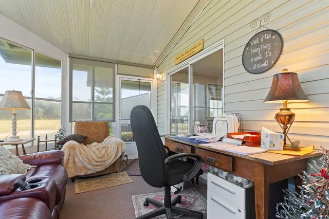 a workspace with furniture and a large window