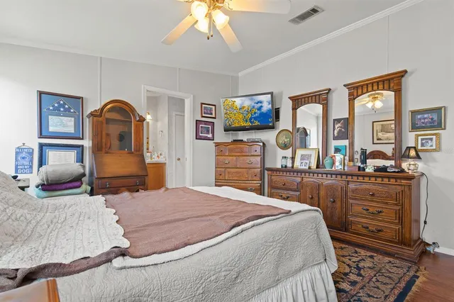 a bedroom with a bed and dresser with mirror