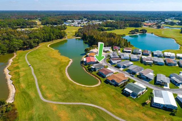 an aerial view of residential houses with outdoor space and swimming pool