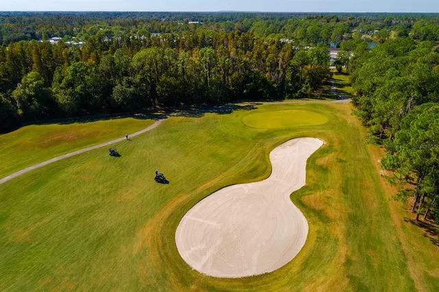 a view of a swimming pool with an outdoor space and seating area